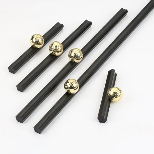 Möbelgriff Nigua – schwarzer länglicher Griff mit dekorativer goldener Kugel für Schränke und Schubladen, moderner Aufsatzgriff, erhältlich im Shop egriffe.at