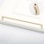Langer Möbelgriff Loma in gebürstetem Gold mit einem Lochabstand von 320 mm.