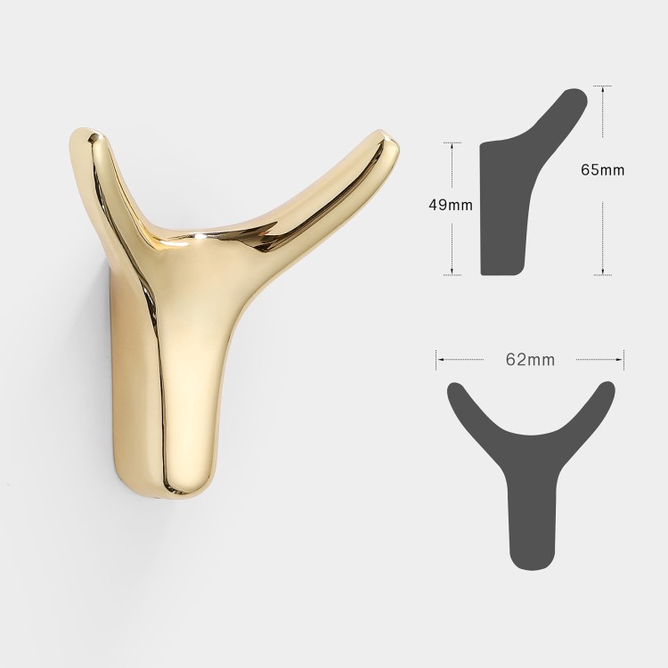 Wandhaken Dorado – moderner Doppelhaken mit eleganter Form, ideal für Jacken, Taschen und Schlüssel. Robust, einfache Montage mit Schrauben im Set. Farben: Gold, gebürstetes Gold, Schwarz und Perlgrau.