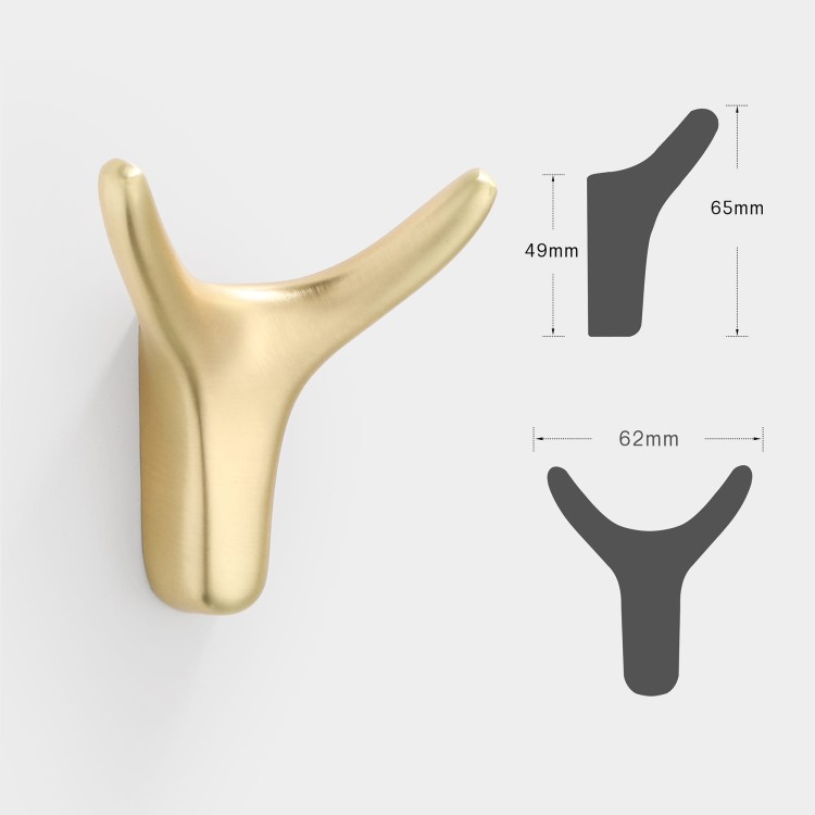 Wandhaken Dorado – moderner Doppelhaken mit eleganter Form, ideal für Jacken, Taschen und Schlüssel. Robust, einfache Montage mit Schrauben im Set. Farben: Gold, gebürstetes Gold, Schwarz und Perlgrau.